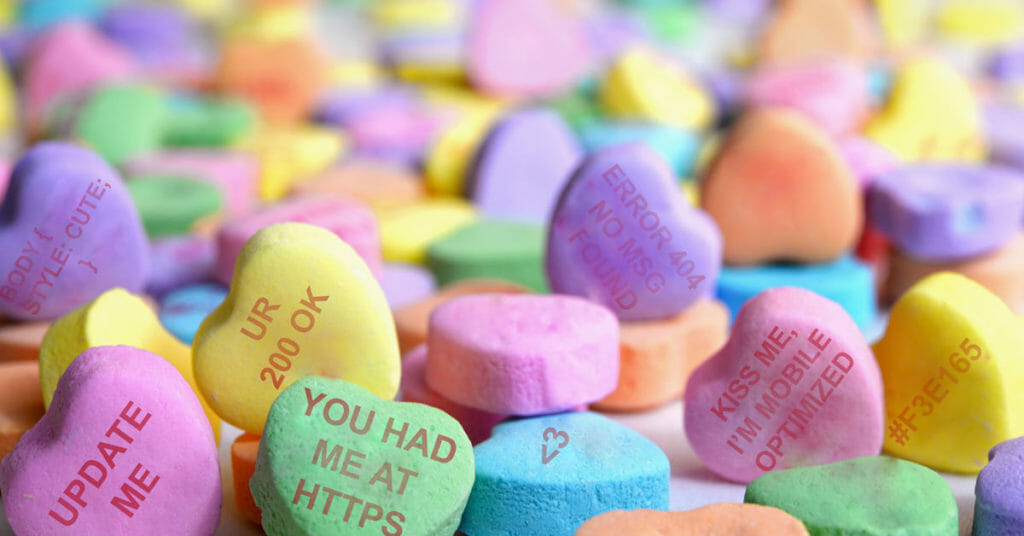 Conversation heart candies with website phrases on them